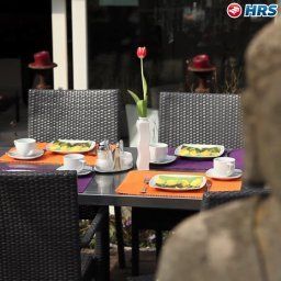 Salle du petit-déjeuner située dans le restaurant Ambiente et Art Fotos