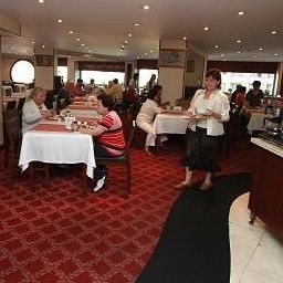 Salle du petit-déjeuner située dans le restaurant Mosaic Hotel Fotos